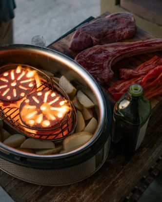 Two lit Cobb Cobblestones inside Cobb Supreme cooker