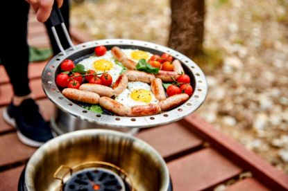 Sausage, eggs and tomatoes cooked in the Cobb fry pan on garden decking