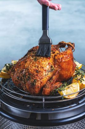 Roast chicken cooking on the Cobb cooker