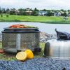 Cobb Premier+ Gas portable cooker grilling salmon fillets on the river bank