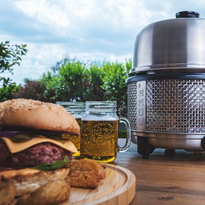 Hamburgers cooked on the Cobb Premier+ Gas portable cooker