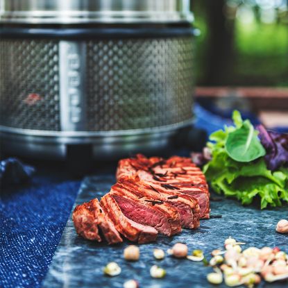 sliced steak cooked on the Cobb Premier+ Gas portable cooker